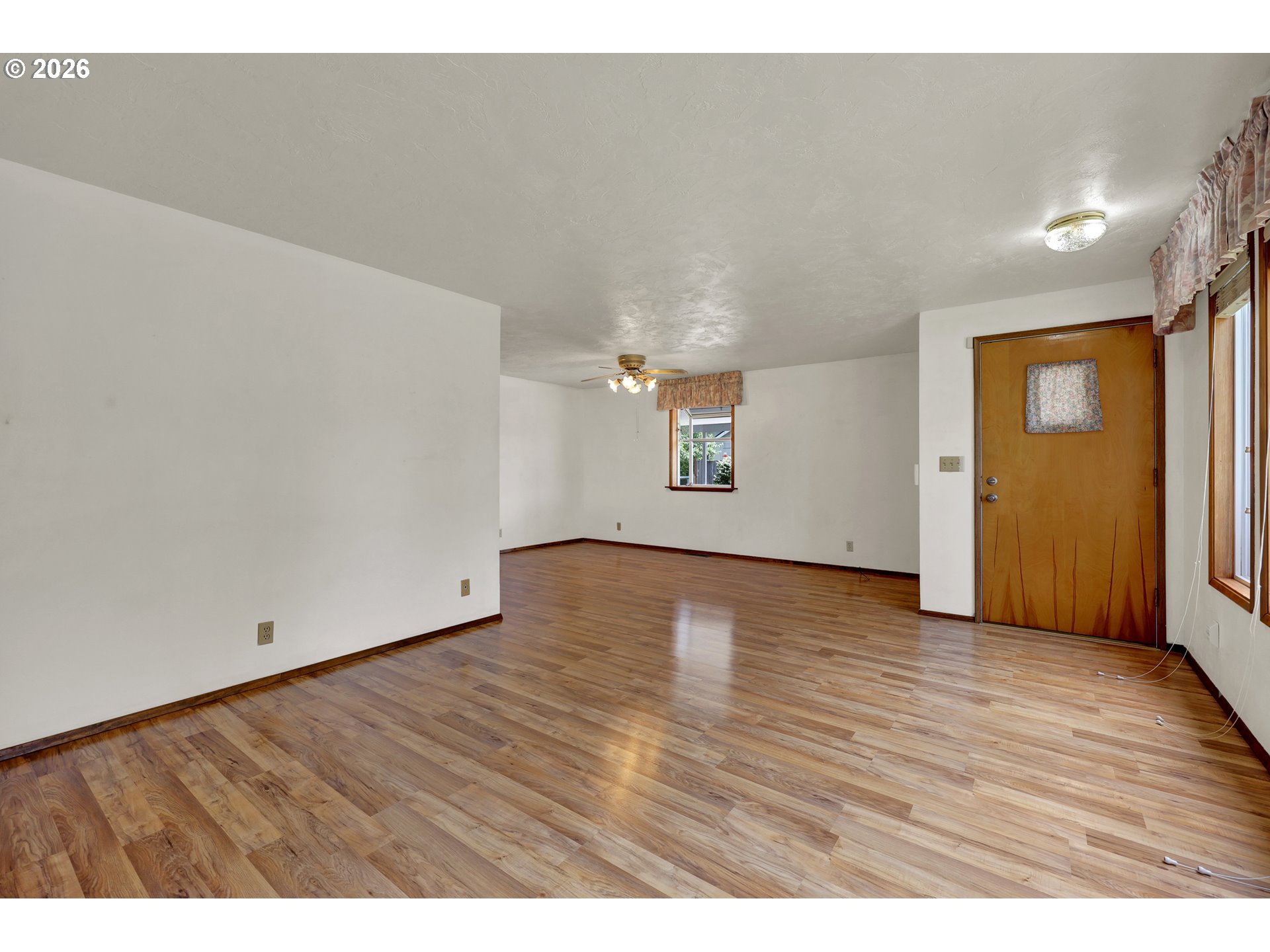 1425 Taney Street Eugene, OR 97402 - Photo 6 of 34 an empty room with wooden floor and windows