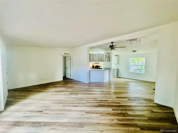 a view of a room with wooden floor
