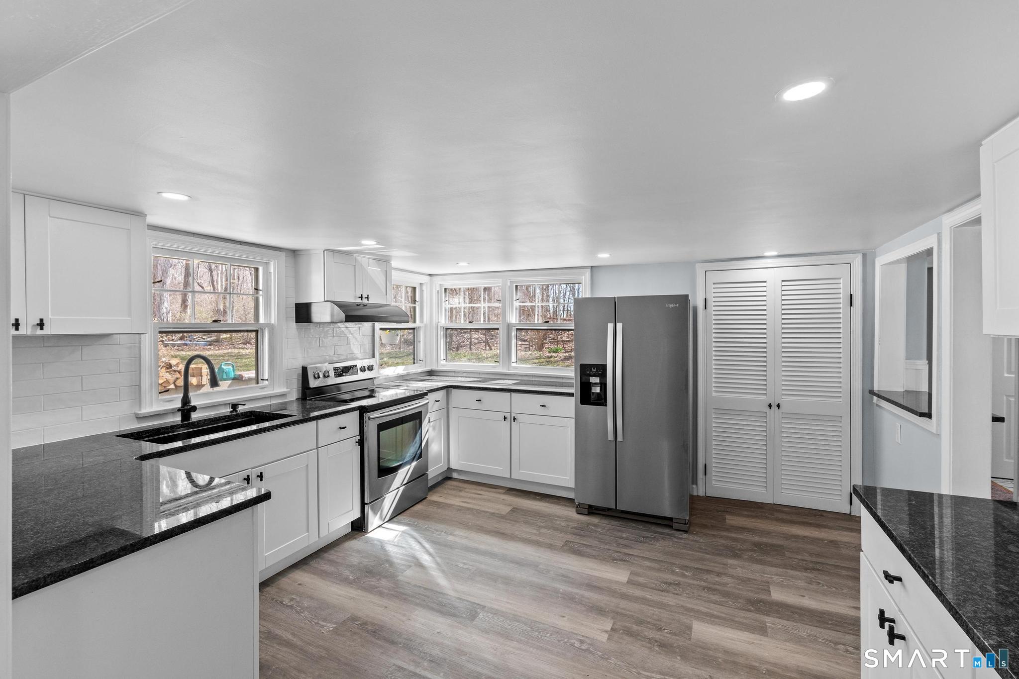 128 Machine Shop Hill Road Windham, CT 06266 - Photo 11 of 45 a kitchen with stainless steel appliances a refrigerator sink and cabinets
