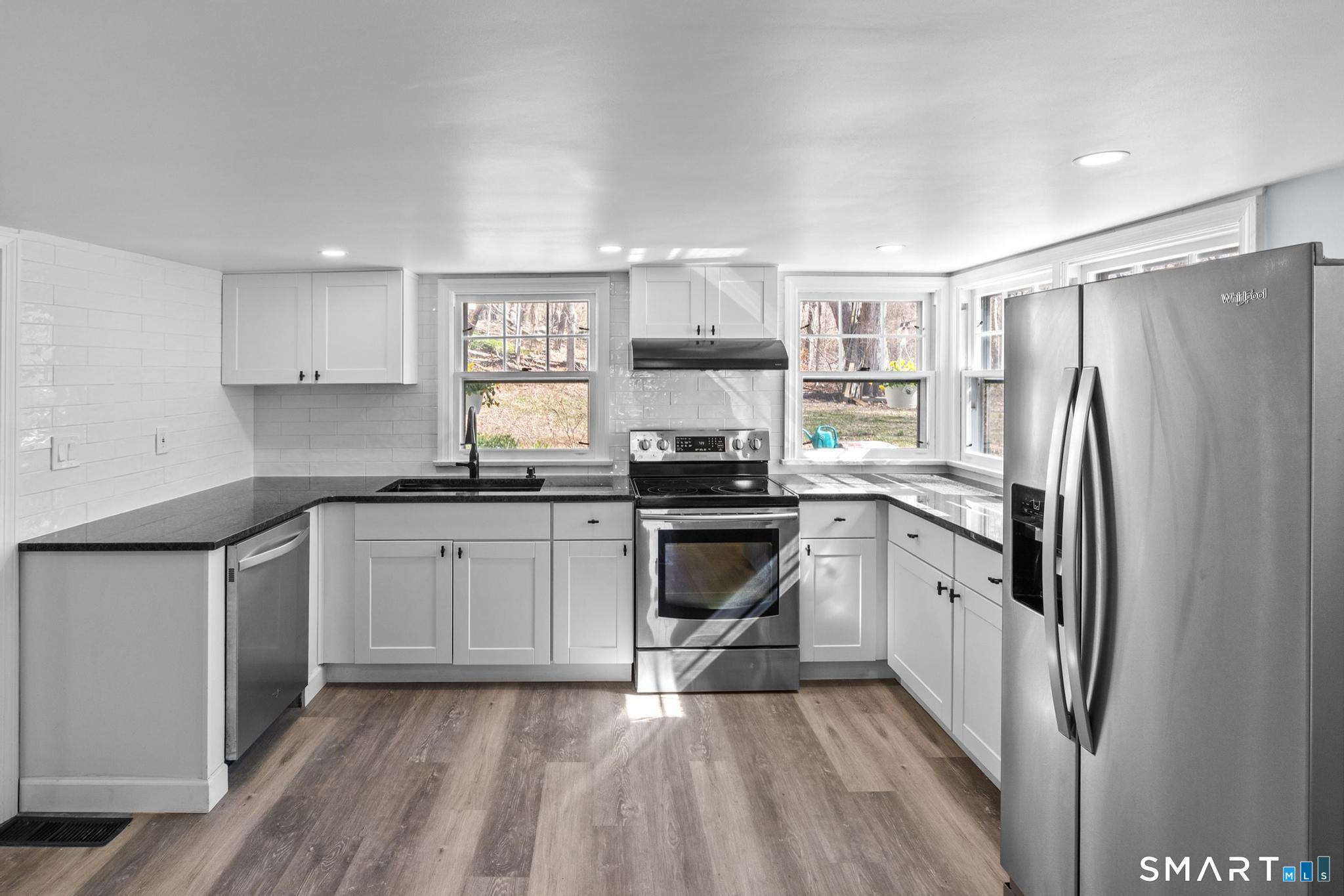 128 Machine Shop Hill Road Windham, CT 06266 - Photo 12 of 45 a kitchen with granite countertop a refrigerator stove top oven and sink