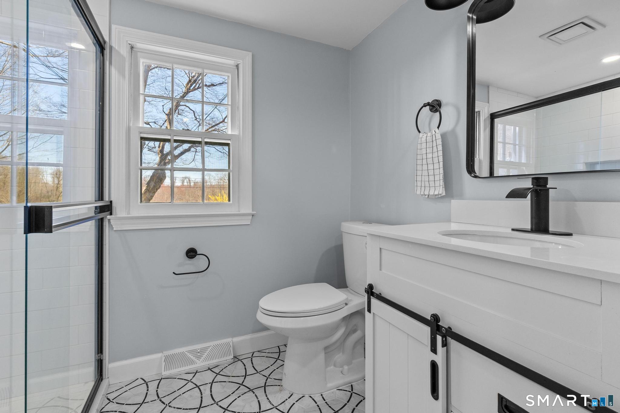 128 Machine Shop Hill Road Windham, CT 06266 - Photo 16 of 45 a bathroom with a sink a toilet and a window