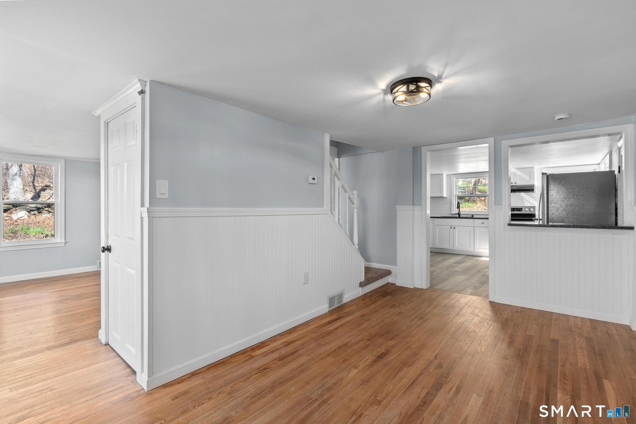 128 Machine Shop Hill Road Windham, CT 06266 - Photo 26 of 45 a view of a kitchen with wooden floor and a refrigerator
