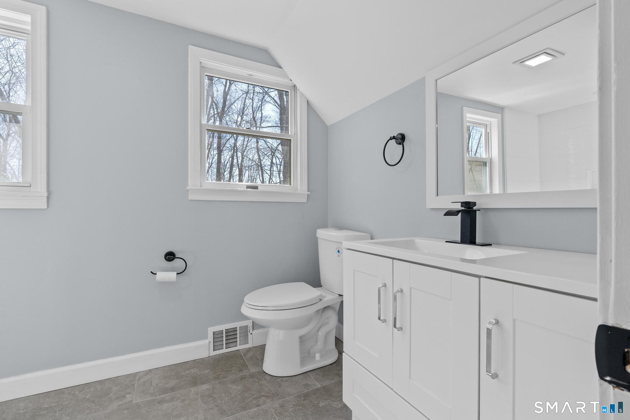 128 Machine Shop Hill Road Windham, CT 06266 - Photo 31 of 45 a bathroom with a toilet a sink a mirror a window and vanity