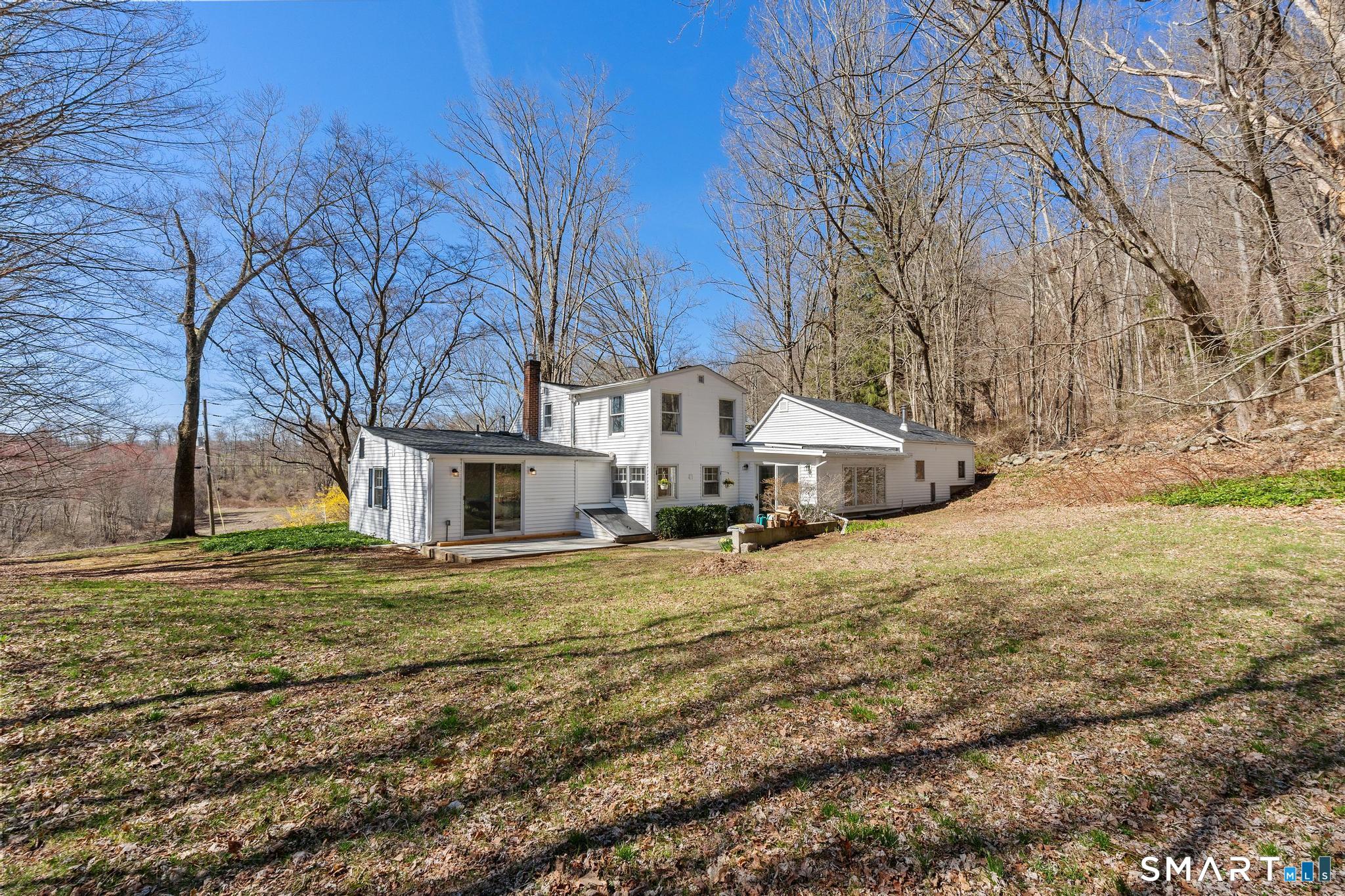 128 Machine Shop Hill Road Windham, CT 06266 - Photo 9 of 45 a big house with trees in front of it