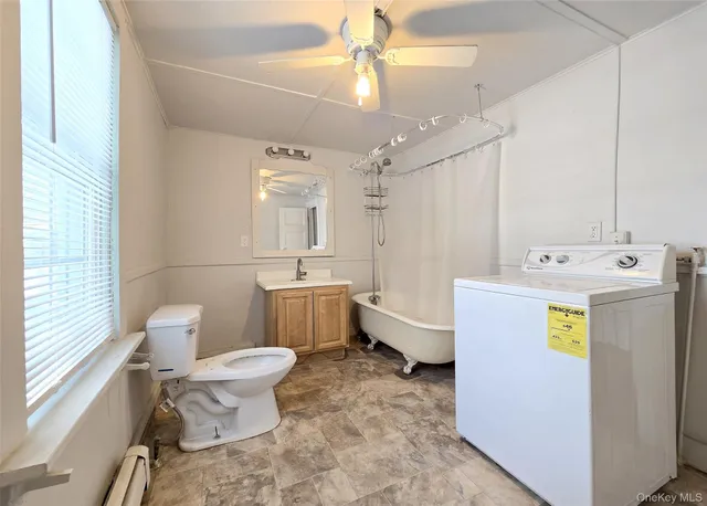 a bathroom with a sink mirror vanity and toilet