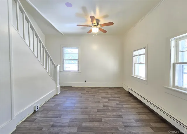 wooden floor in an empty room with a window