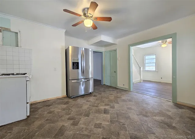 a view of a kitchen with a sink and a refrigerator
