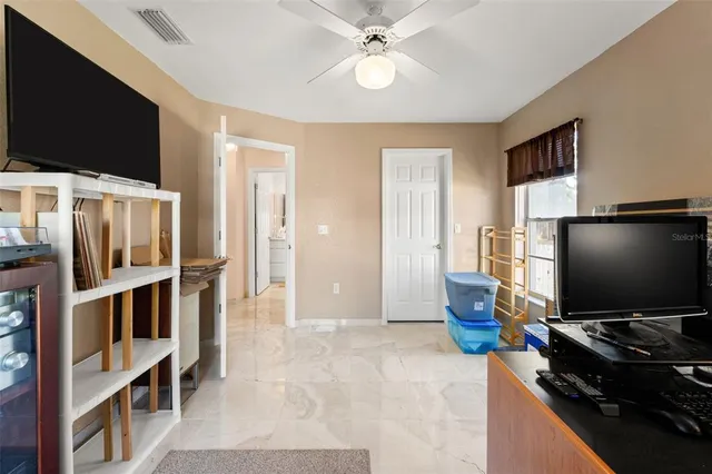 a view of a patio with a table and chairs under an umbrella