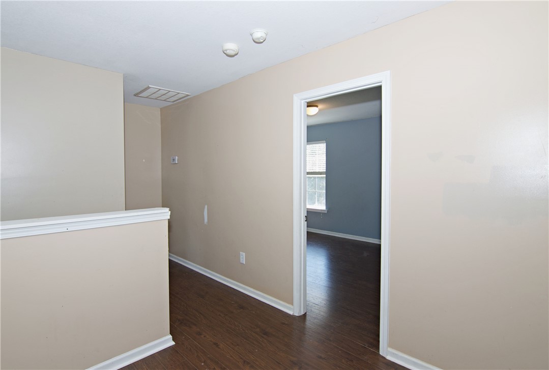 305 North Chestnut Street Seneca, SC 29678 - Photo 23 of 44 Rich hardwood floors flow through this welcoming hallway, leading to a sun-filled room.