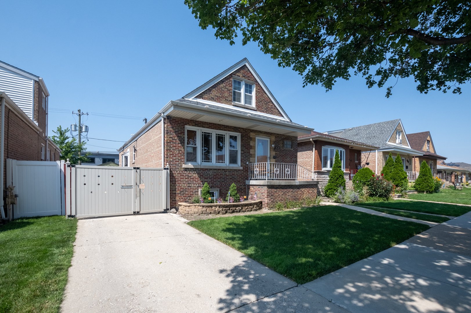 a front view of a house with a yard and trees