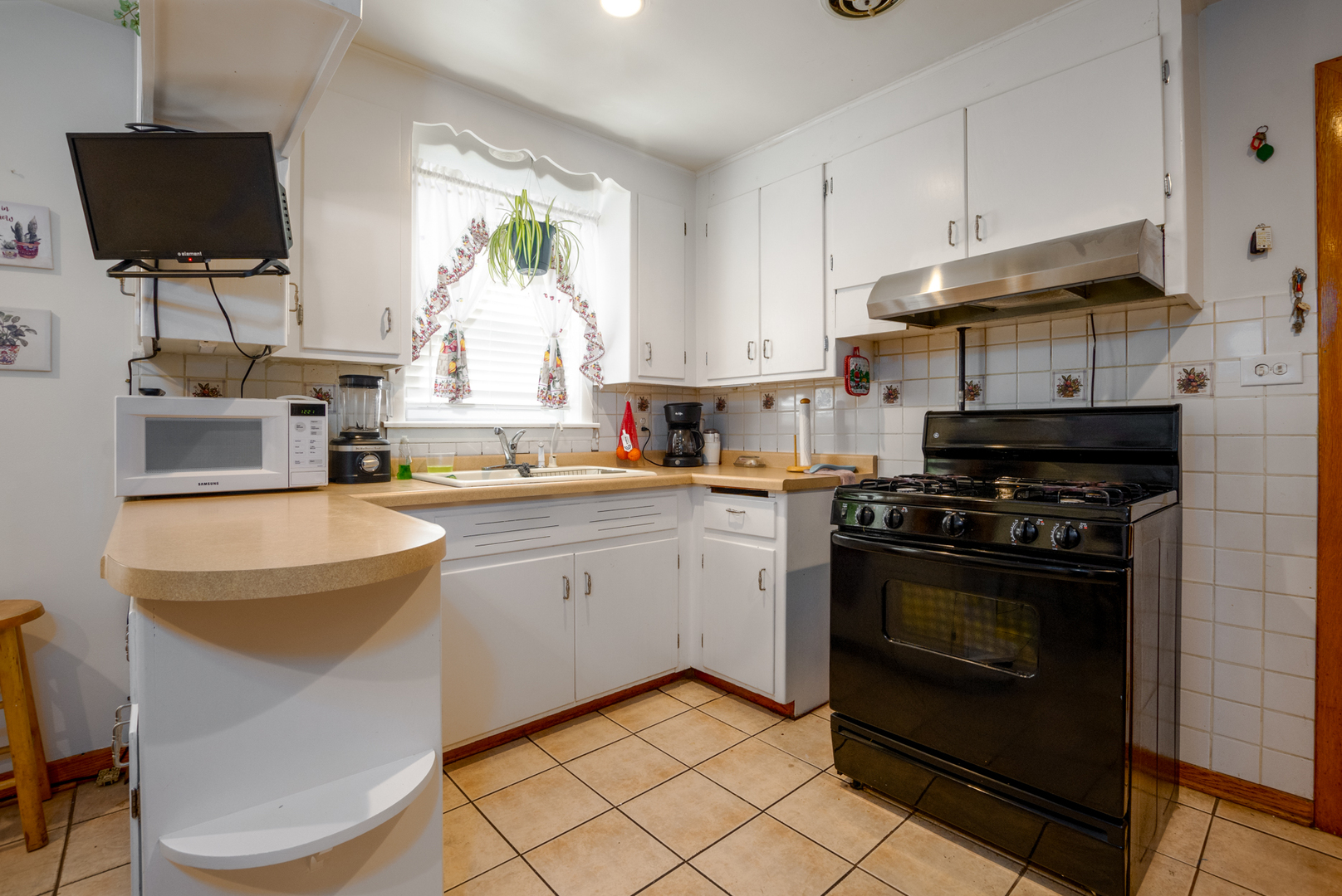 5328 South Harding Avenue Chicago, IL 60632 - Photo 11 of 26 a kitchen with a stove a sink and a microwave