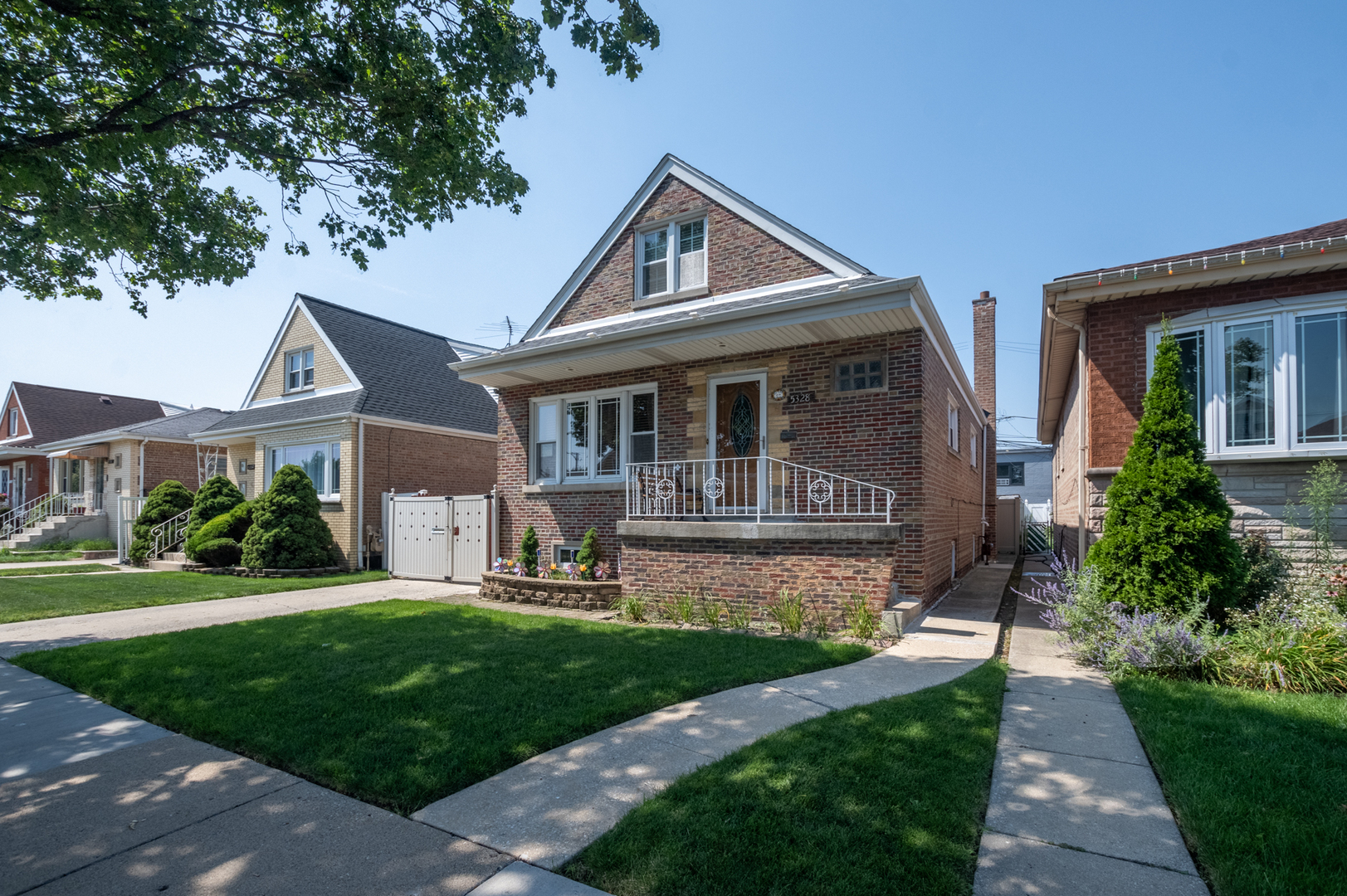 5328 South Harding Avenue Chicago, IL 60632 - Photo 2 of 26 a front view of a house with a yard