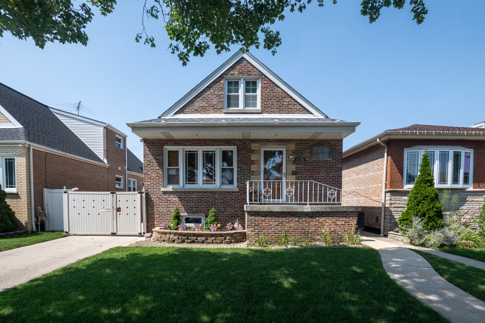 5328 South Harding Avenue Chicago, IL 60632 - Photo 3 of 26 a front view of a house with a garden and porch
