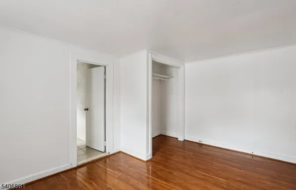 a view of an empty room and wooden floor