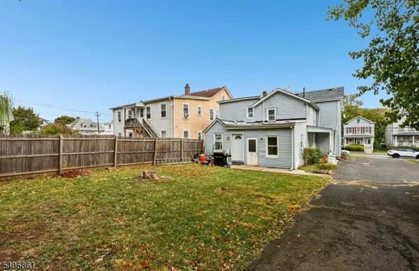 a view of a house with a big yard and large trees