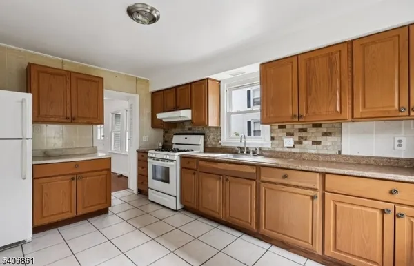 a kitchen with sink cabinets and window