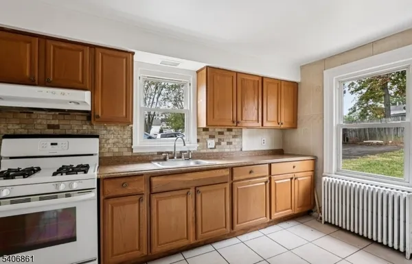 a kitchen with a sink stove and cabinets