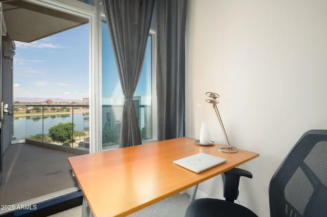 a view of a workspace with a table and chair