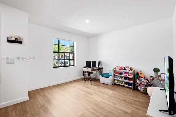 a view of a room with toys and wooden floor