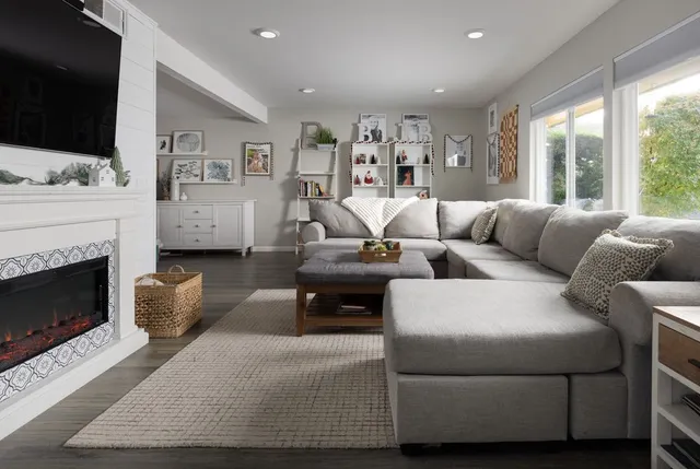 a living room with furniture fireplace and flat screen tv