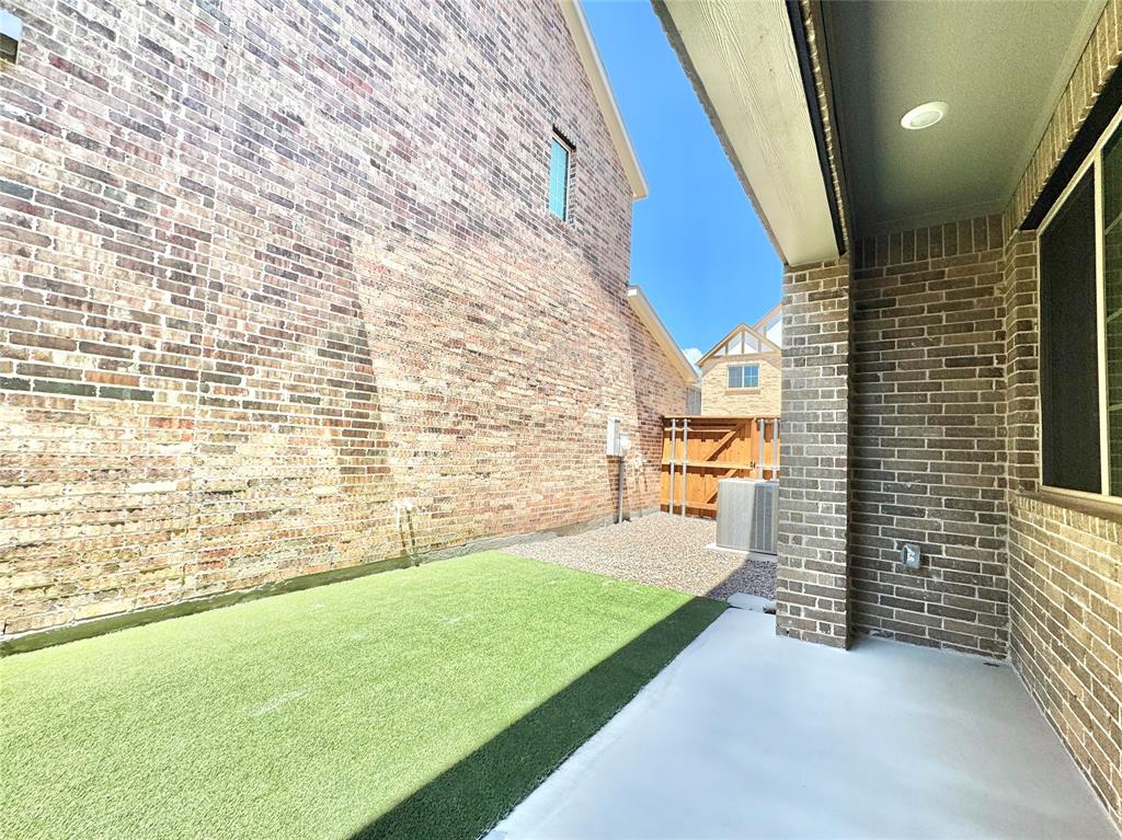 8749 Scotty's Lk Lane The Colony, TX 75056 - Photo 12 of 33 View of yard with central air condition unit and a patio area