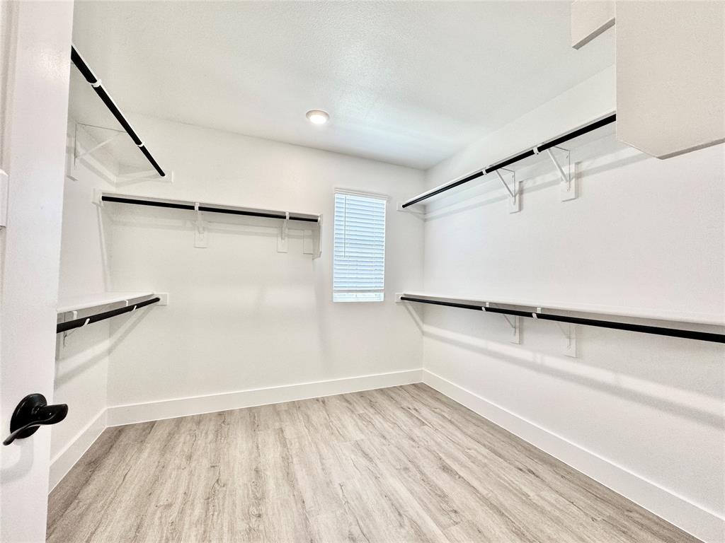 8749 Scotty's Lk Lane The Colony, TX 75056 - Photo 18 of 33 Spacious closet with wood finished floors
