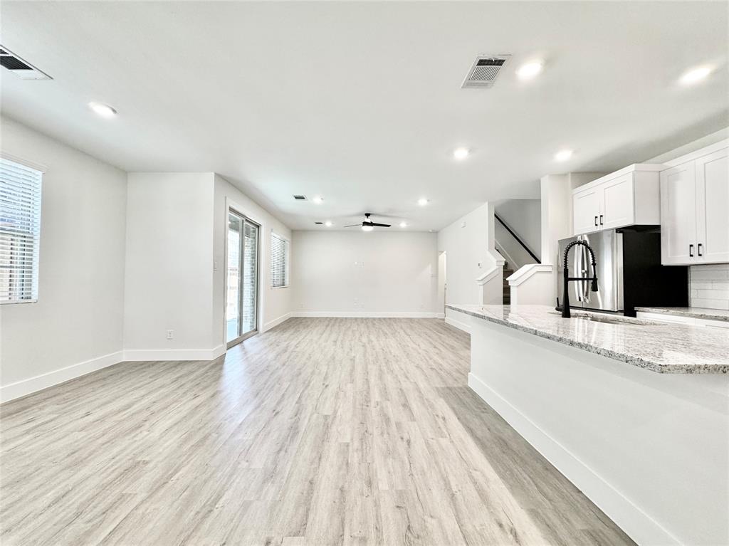 8749 Scotty's Lk Lane The Colony, TX 75056 - Photo 3 of 33 Unfurnished living room with recessed lighting, light wood finished floors, stairs, a ceiling fan, and baseboards