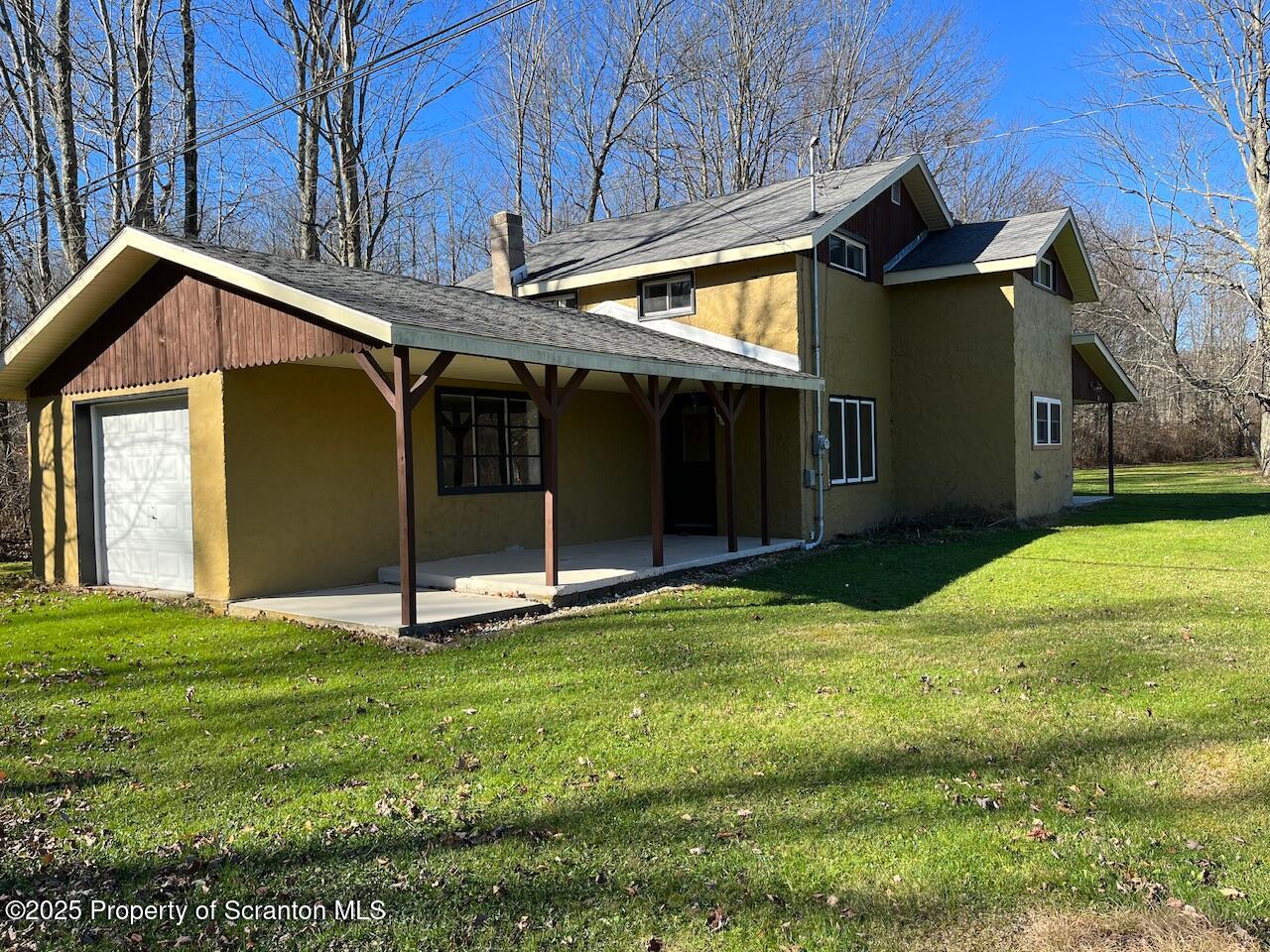 3191 Aberdeen Road Moscow, PA 18444 - Photo 2 of 14 a house that has a big yard with wooden fence