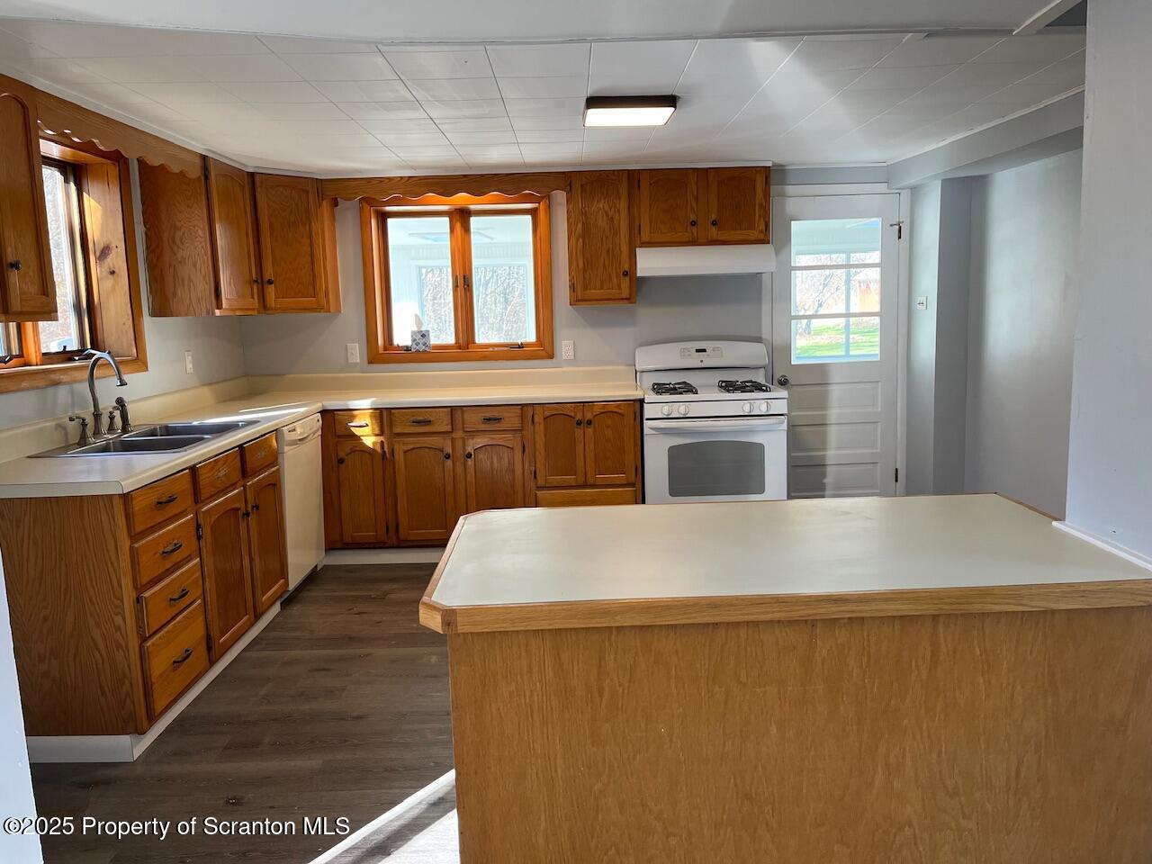 3191 Aberdeen Road Moscow, PA 18444 - Photo 4 of 14 a kitchen with a stove a sink a microwave and a refrigerator