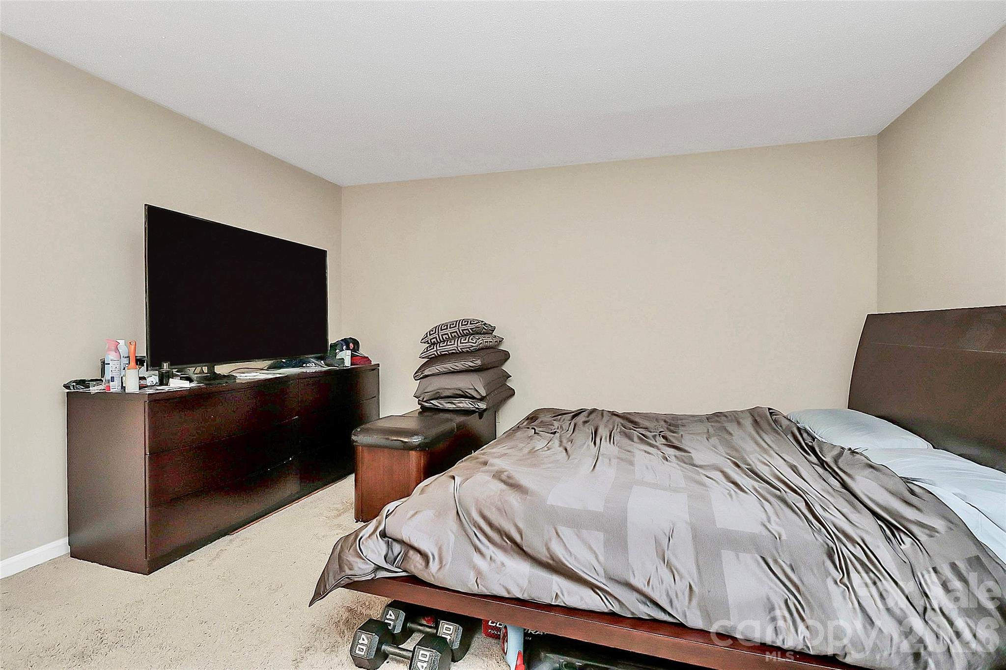 11115 Park Road Charlotte, NC 28226 - Photo 16 of 21 a bedroom with a bed and a flat screen tv