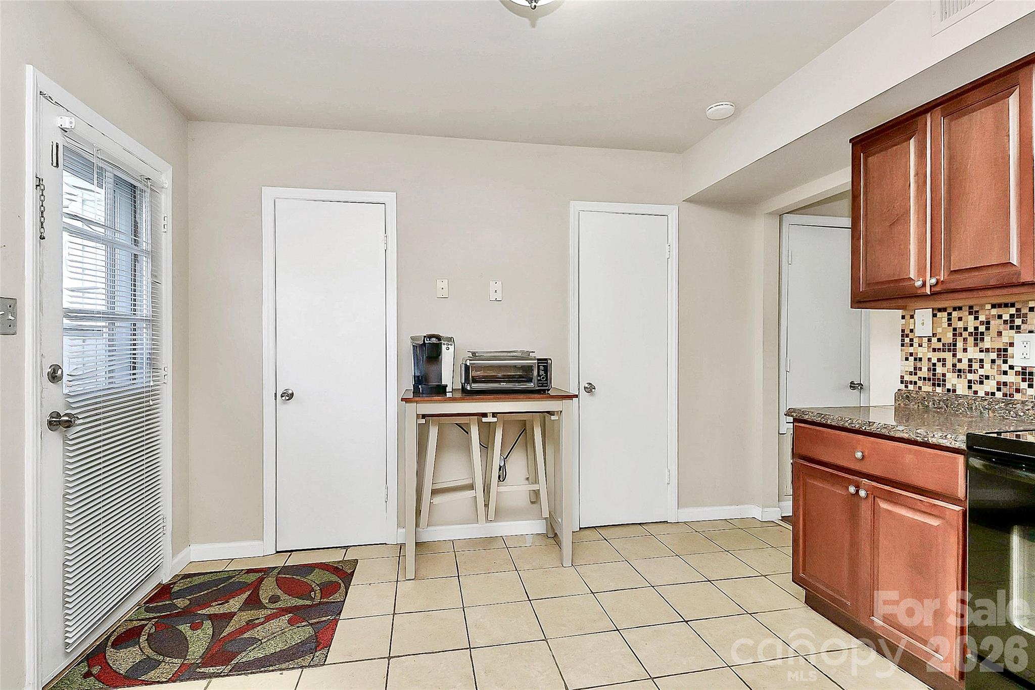 11115 Park Road Charlotte, NC 28226 - Photo 19 of 21 a kitchen with granite countertop a stove top oven and cabinets