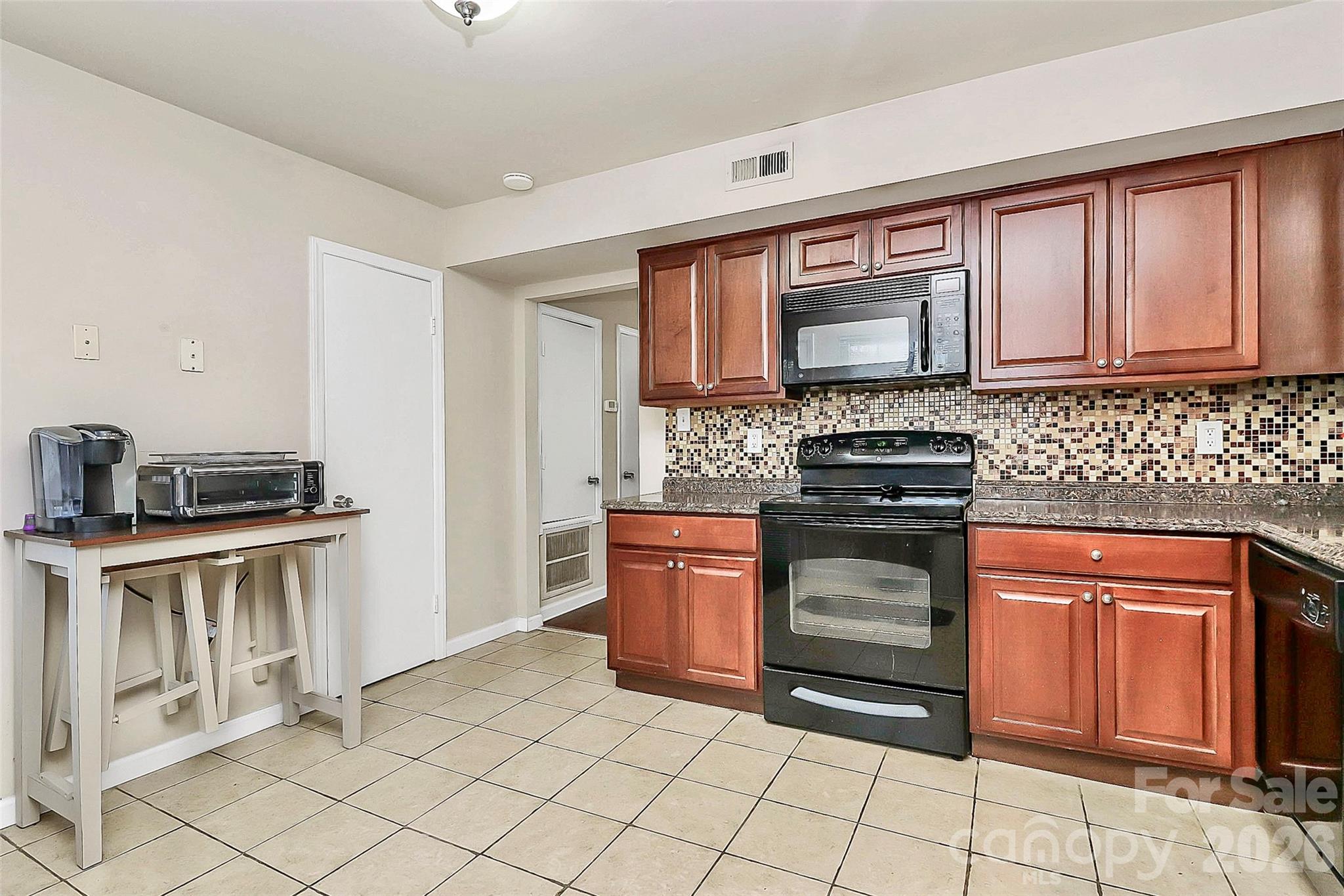 11115 Park Road Charlotte, NC 28226 - Photo 20 of 21 a kitchen with stainless steel appliances granite countertop a stove sink and cabinets