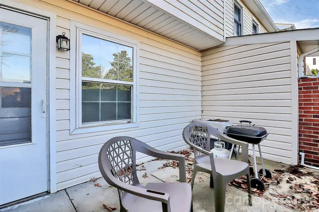 a view of a porch with furniture and front door
