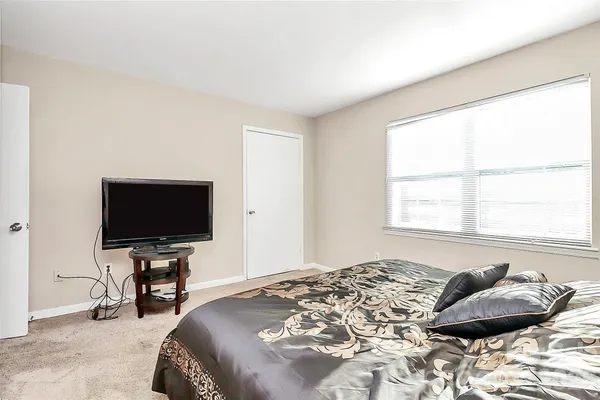 a bedroom with a bed and television