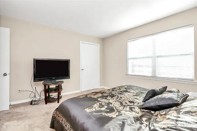 a bedroom with a bed and television