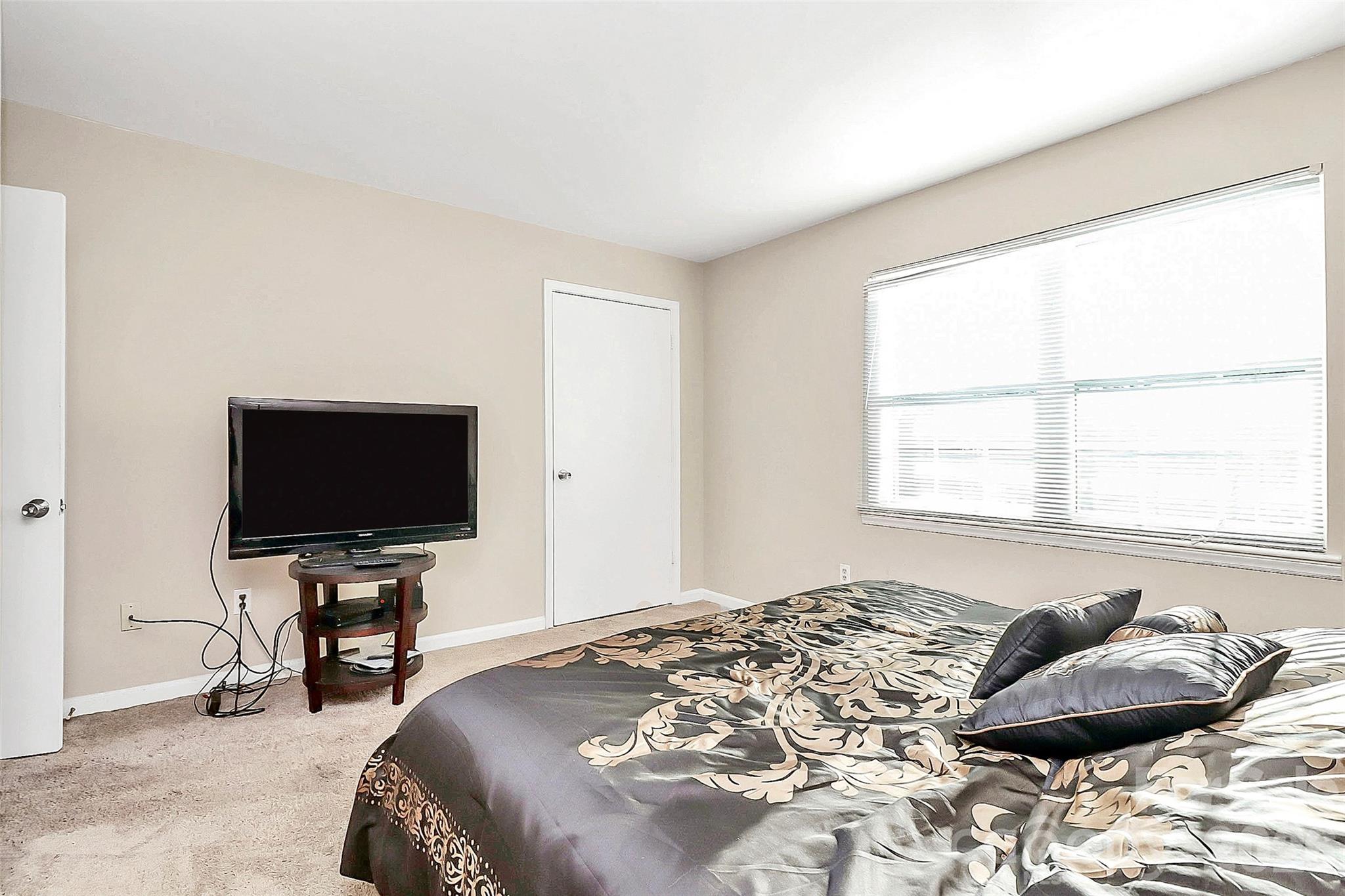 11115 Park Road Charlotte, NC 28226 - Photo 7 of 21 a bedroom with a bed and television