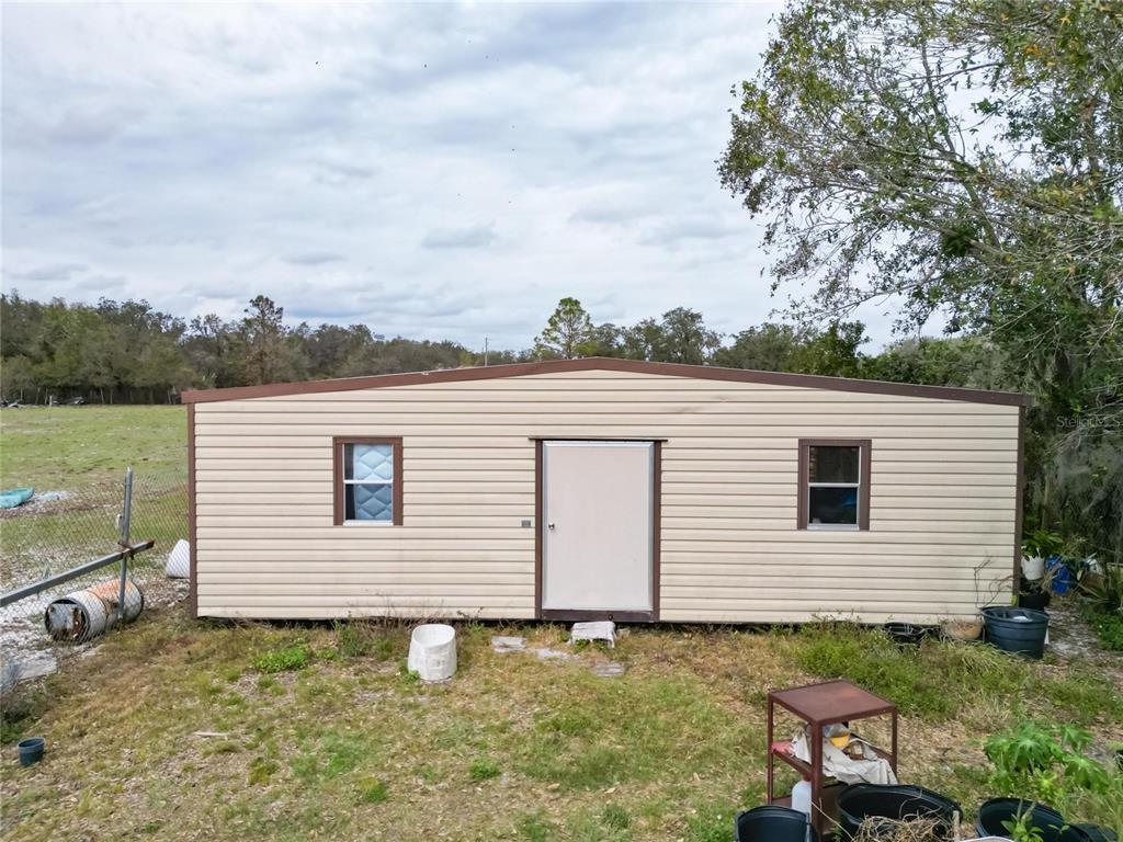 17273 Alderman Turner Road Wimauma, FL 33598 - Photo 36 of 60 a backyard of a house with table and chairs