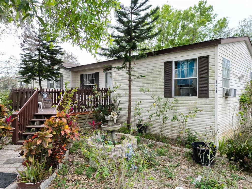 17273 Alderman Turner Road Wimauma, FL 33598 - Photo 43 of 60 a view of a chair and table in the backyard