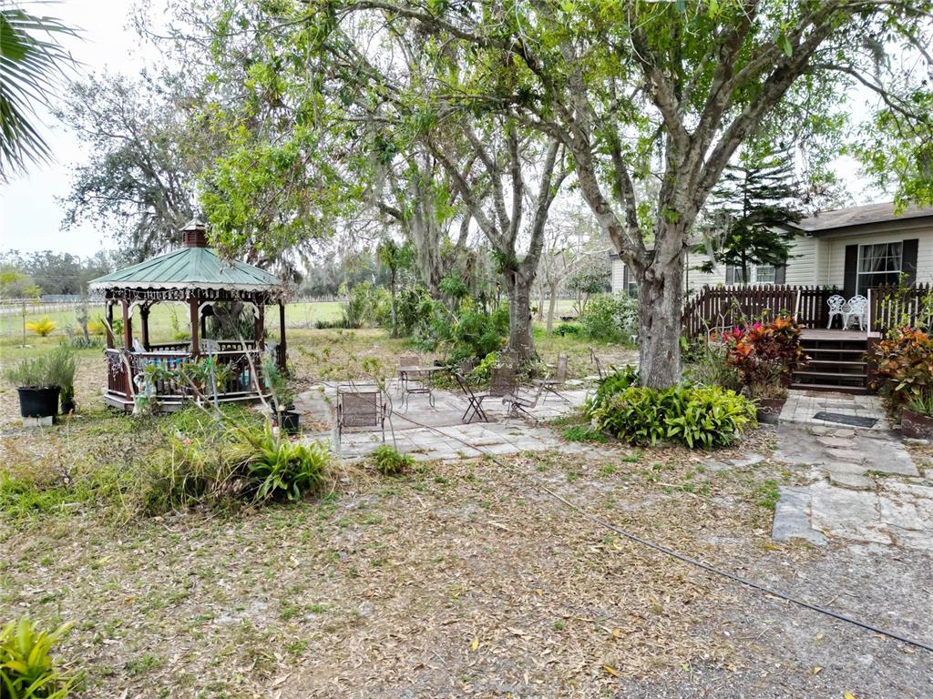 17273 Alderman Turner Road Wimauma, FL 33598 - Photo 47 of 60 a front view of a house with garden