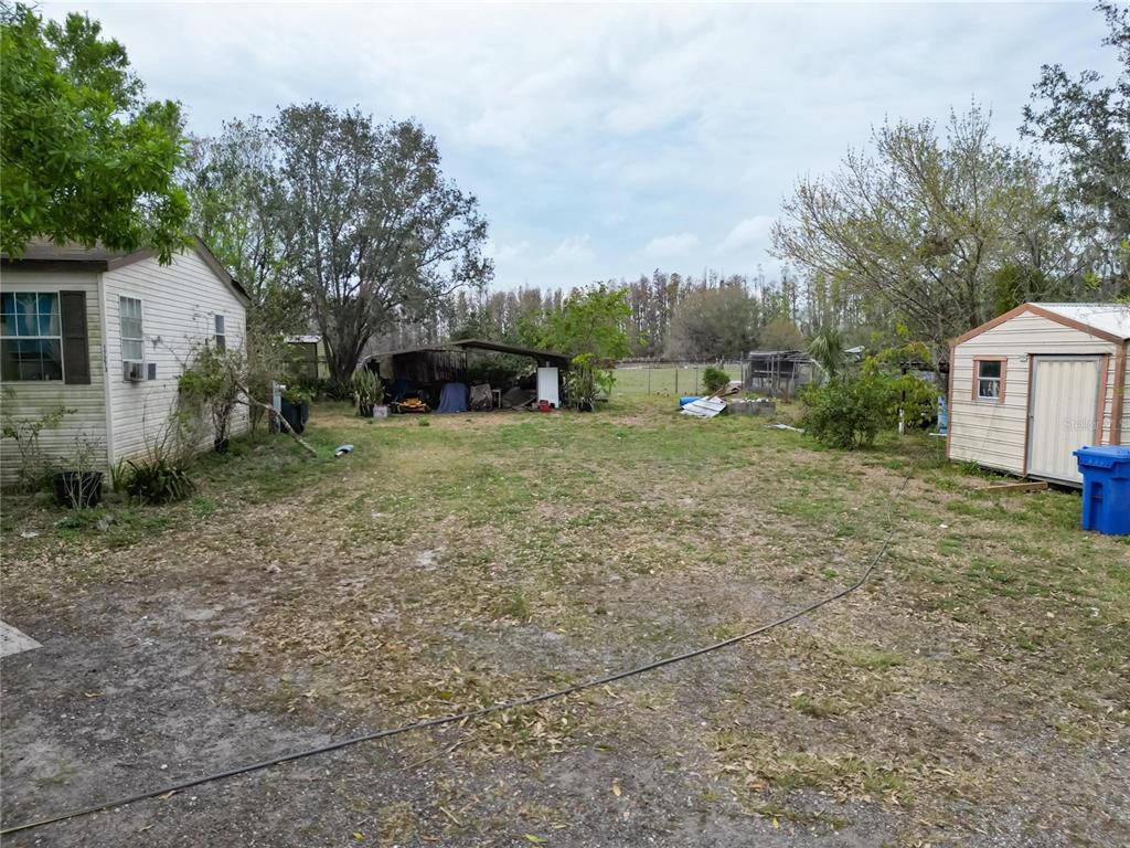 17273 Alderman Turner Road Wimauma, FL 33598 - Photo 49 of 60 a view of a house with a yard