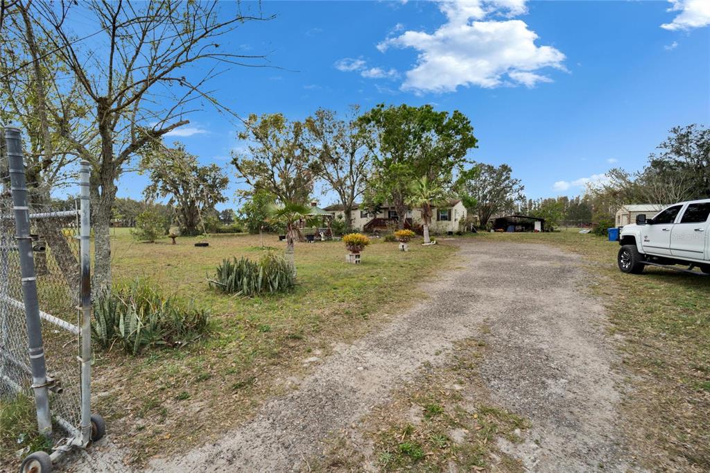 17273 Alderman Turner Road Wimauma, FL 33598 - Photo 54 of 60 a view of dirt field with trees