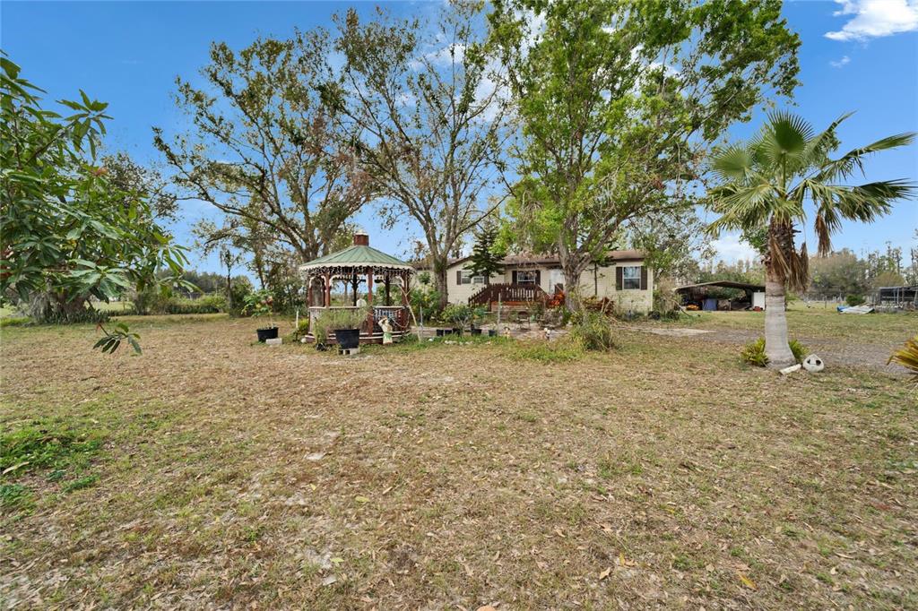 17273 Alderman Turner Road Wimauma, FL 33598 - Photo 60 of 60 a view of outdoor space with garden and trees