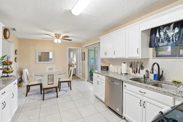 a kitchen with cabinets and chairs