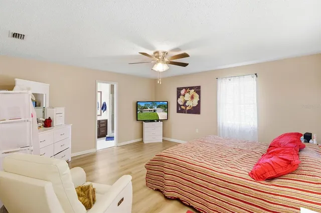 a bedroom with a bed and a couch