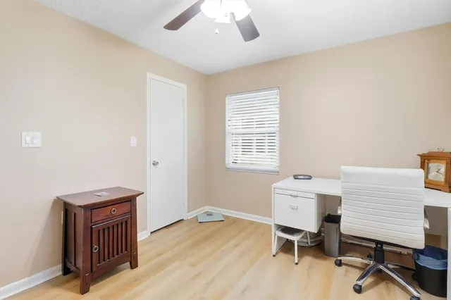 a workspace with furniture hardwood and a window