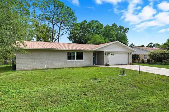 a house that has a big yard and large trees
