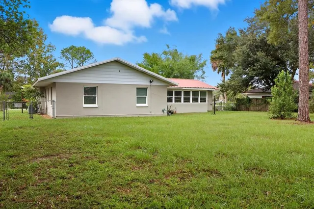 a view of a house with a yard and sitting area