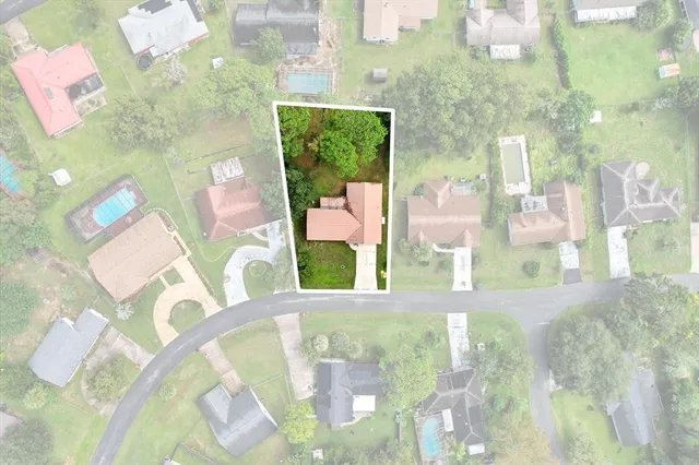an aerial view of multiple houses with yard