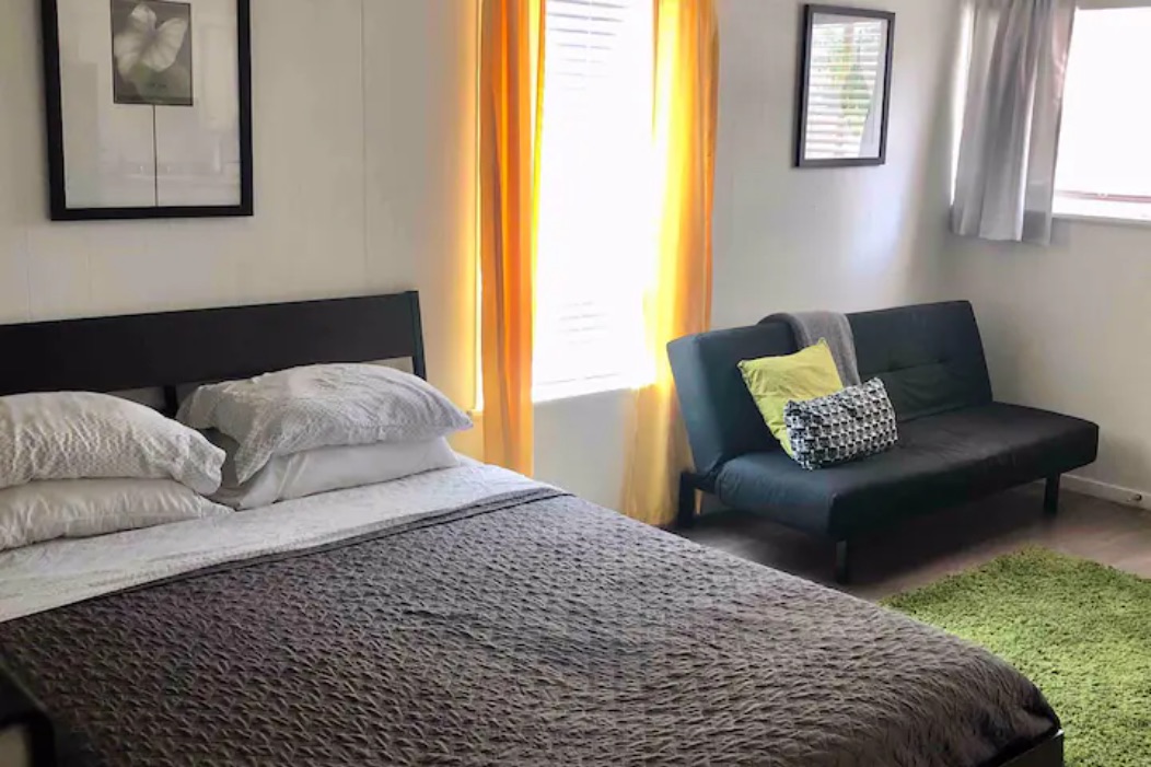 5909 Bolm Road, Unit 2 Austin, TX 78721 - Photo 2 of 10 a bedroom with a bed couch and window