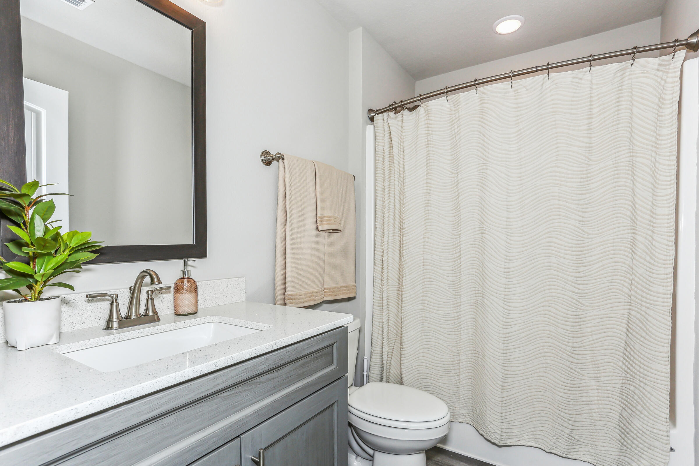 4851 Horace Lunsford Road Milton, FL 32570 - Photo 34 of 38 a bathroom with a sink a toilet a mirror and shower curtain